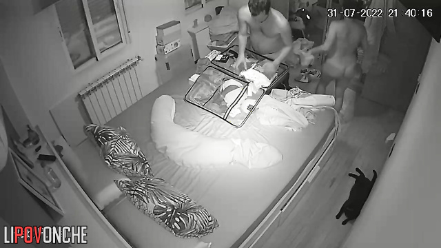 Man and pregnant woman pack suitcases naked in bedroom