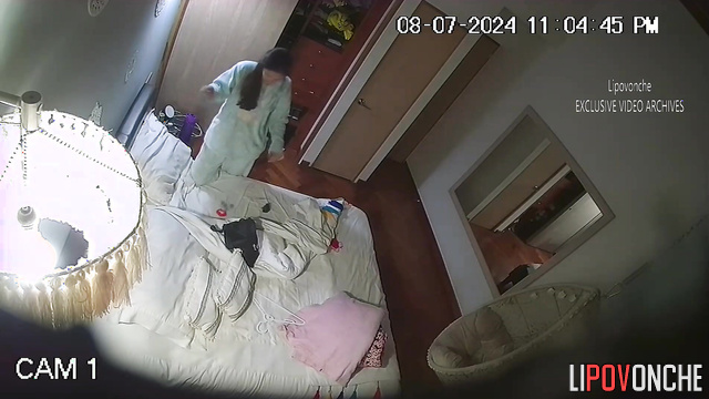 Brunette with long hair masturbates to porn in the bedroom