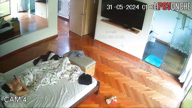 Brunette with beautiful breasts jerks off a man in bed