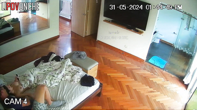 Brunette with beautiful breasts jerks off a man in bed