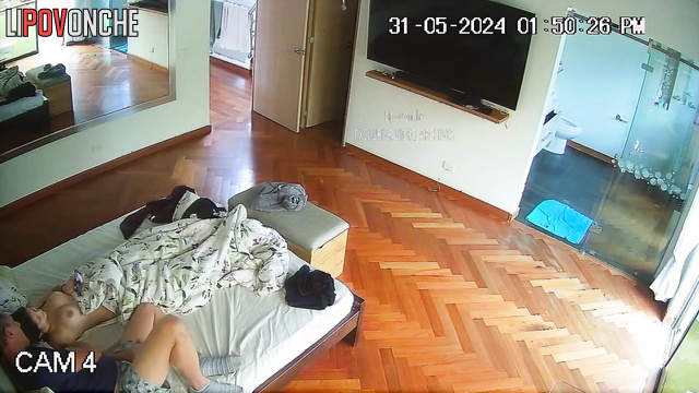 Brunette with beautiful breasts jerks off a man in bed