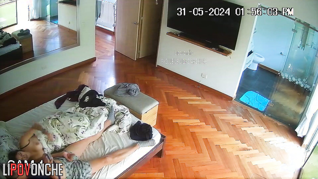 Brunette with beautiful breasts jerks off a man in bed