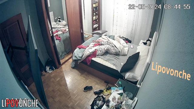 Brunette with tattoos changes clothes in the bedroom