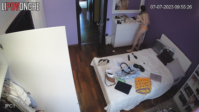 Cute brunette is thinking about what to wear on a date