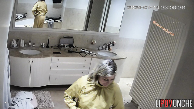 Old woman undressing in her huge bathroom right now