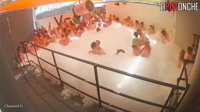 Naked women and men dance in foam at the adult party