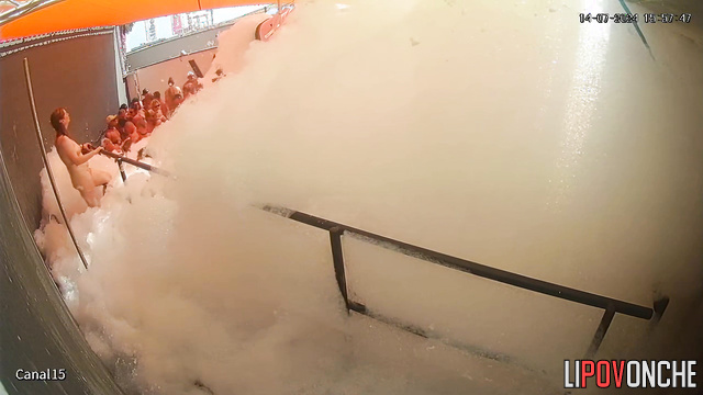 People kissing right in the foam (swinger pool party)