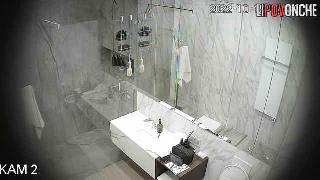 A loving couple takes turns taking a shower in the bathroom