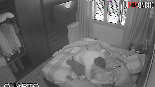 Cute couple kissing and being affectionate on bed in bedroom