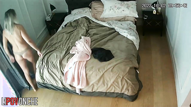 Skinny blonde in thong and bare tits makes bed in bedroom