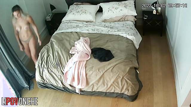 Skinny blonde in thong and bare tits makes bed in bedroom