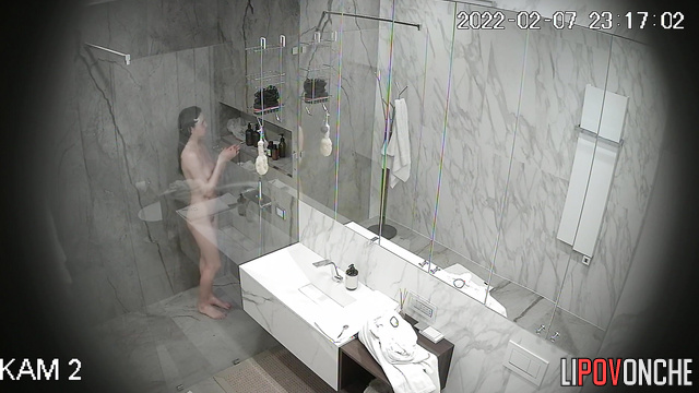 Skinny brunette with long hair takes a shower and shaves