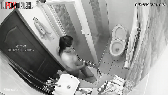 The long-haired brunette went to the toilet and took a shower