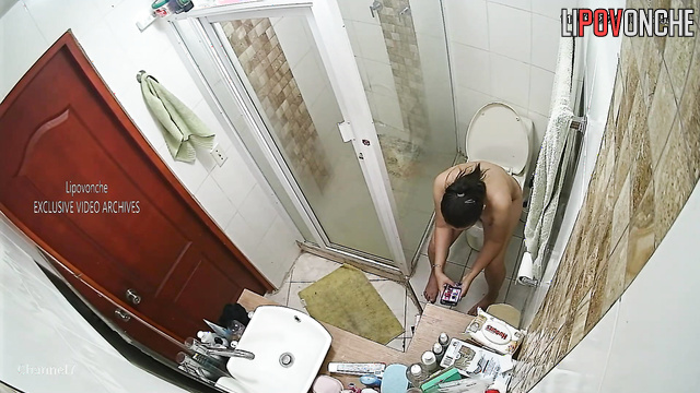 The long-haired brunette went to the toilet and took a shower