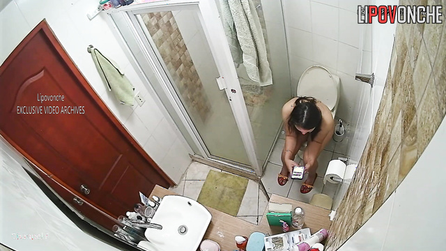 Naked brunette with nipples piercing visited the toilet