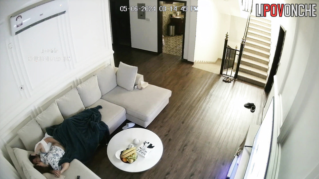 A couple has sex in the living room in front of the TV