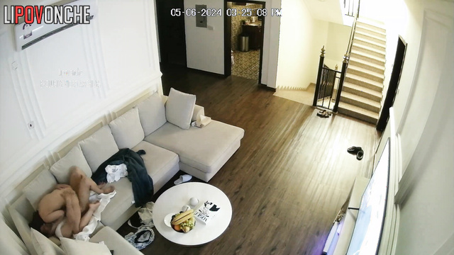 A couple has sex in the living room in front of the TV