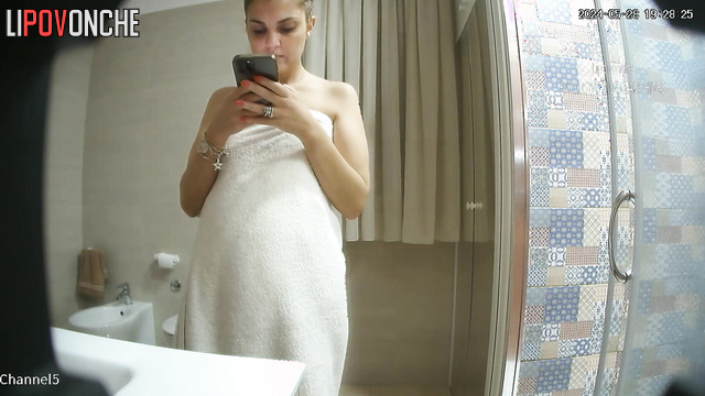 Brunette with glasses came to the bathroom and took a shower