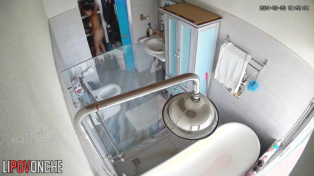 Mature MILF takes a shower and masturbates while sitting in the bathtub