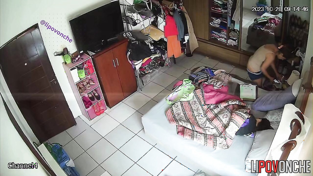 Tanned girl exposes her breasts while changing clothes in the bedroom