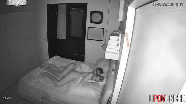 Man watching tv and teasing her at the same time