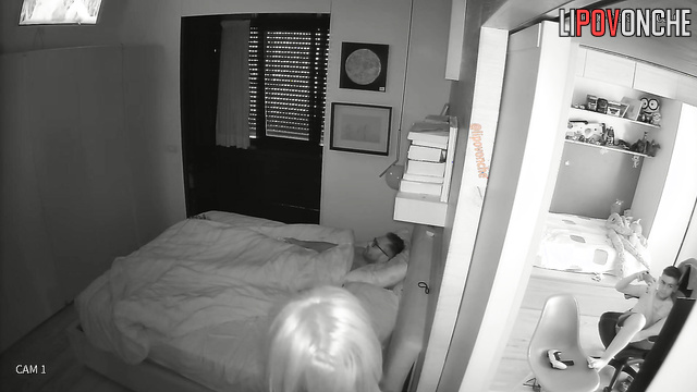 Guy in glasses teasing his girlfriend in the bed