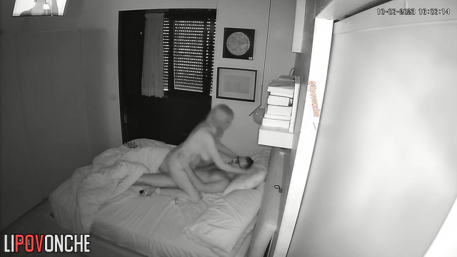 Guy in glasses teasing his girlfriend in the bed