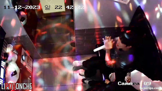 Asian couple enjoying their time in karaoke club