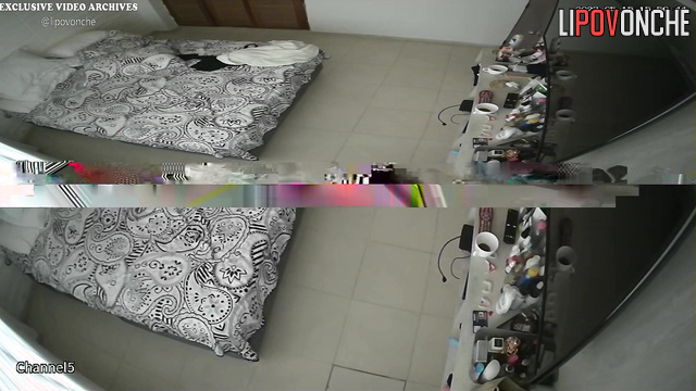 Tattooed couple chilling with phones on the bed
