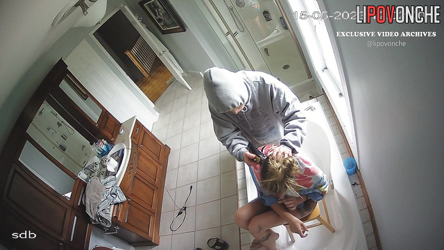 Tattooed bestie cutting hair her blondy, bathroom tape