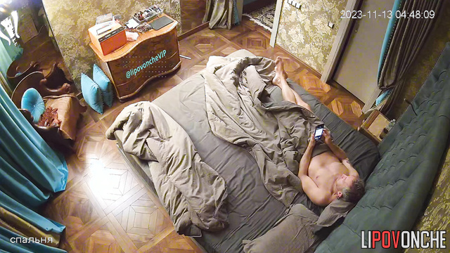 Redhead lady and gray-haired guy having hot conversation on the bed