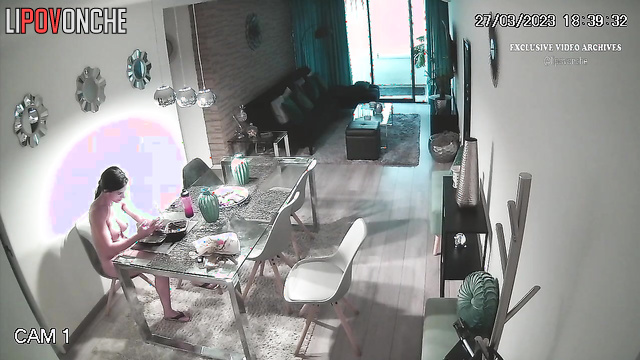 Naked brunette is bored in the living room, watch