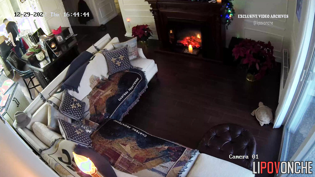 Blonde and her boyfriend chatting near the fireplace
