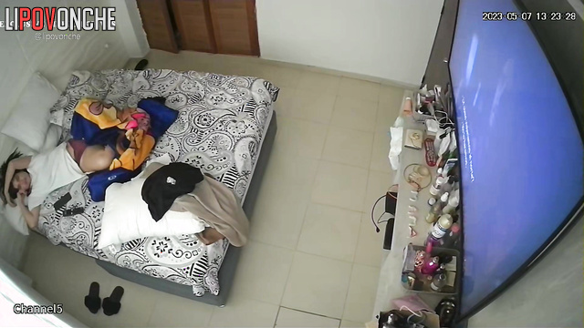 Brunette watching tv and talking to her boy at the same time