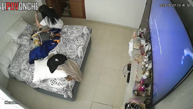 Brunette watching tv and talking to her boy at the same time