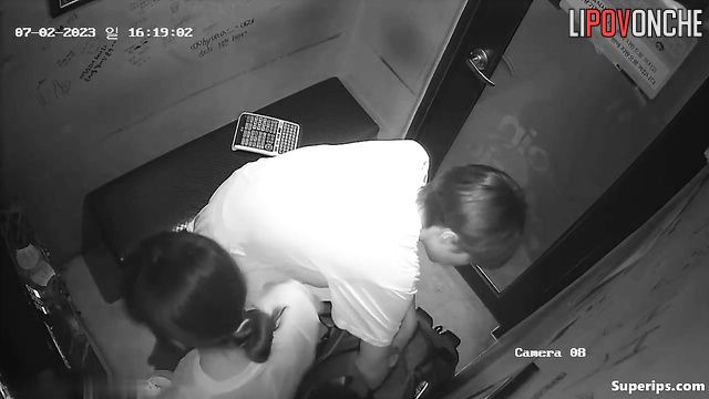 Asian couple having fun in the karaoke club right now