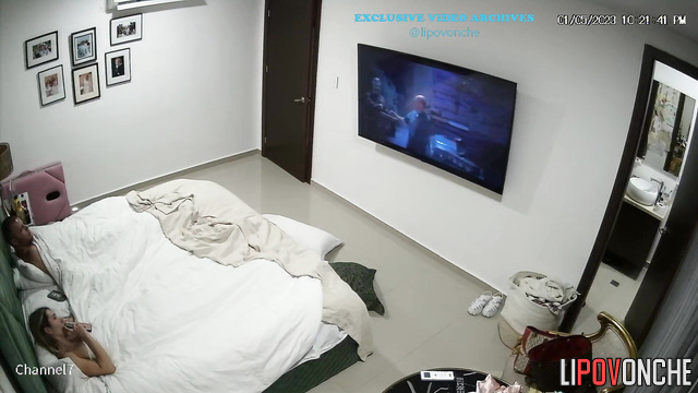 Naked couple watching interesting film under the blanket