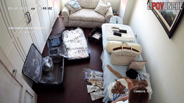 Blonde unpacking her clothes after an exotic trip