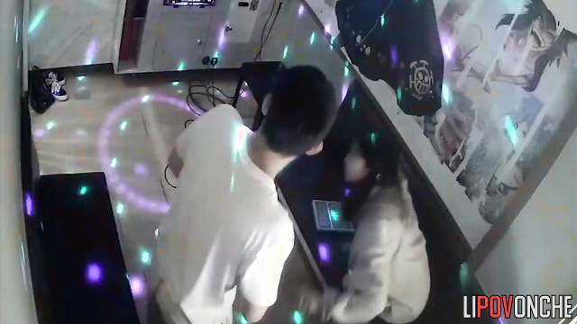 Young brunette sitting on his lap and they singing karaoke