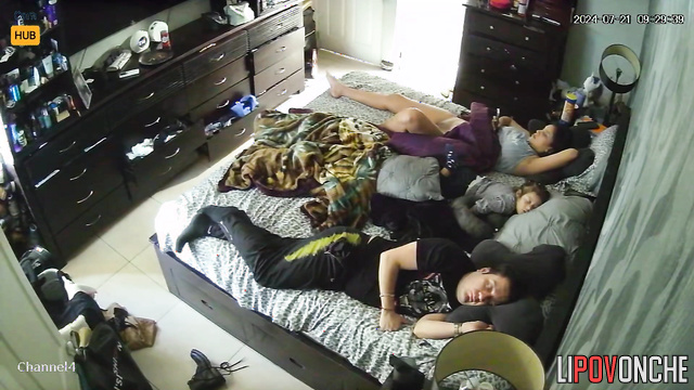 Couple minding their own business while lying on the bed
