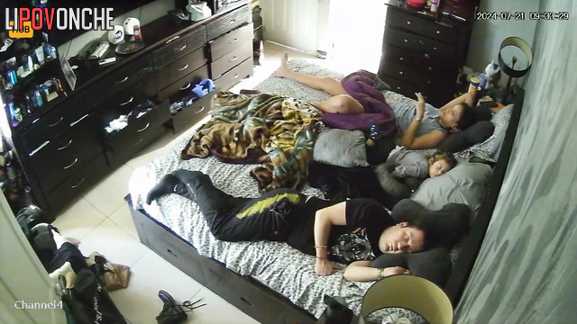 Couple minding their own business while lying on the bed