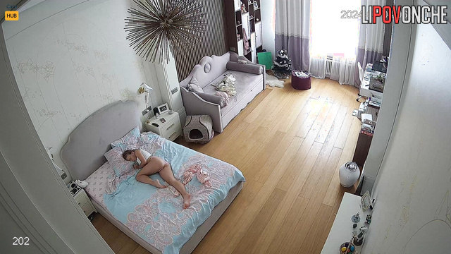 Topless blonde walking around the room where her friend sleeping