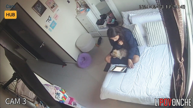 Cute schoolgirl relaxing with tablet on the bed
