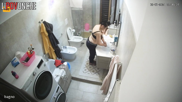 Chubby woman sitting on the toilet and listening to music