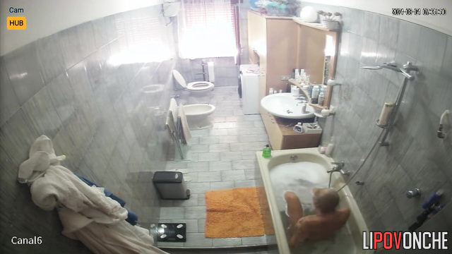 Blonde preparing for work (her husband periodically goes to the bathroom)