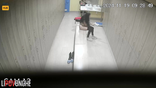 Long-haired russian girl changing clothes in the locker room