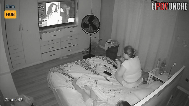 Chubby blonde smoking during tv watching (beside her relative)