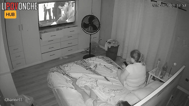 Chubby blonde smoking during tv watching (beside her relative)