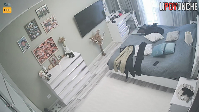 Brunette ironing her clothes before work / bedroom morning scene