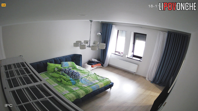 Lonely lady making her bed after sleep, hidden camera